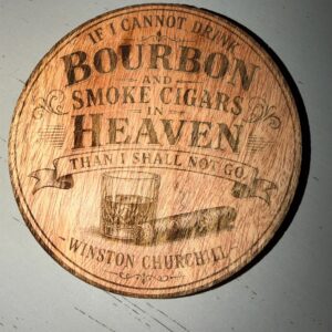 Round wood coaster laser-engraved with a bourbon glass, a cigar, and a bourbon and cigars quote