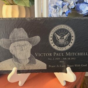 Natural slate memorial plaque laser-engraved with a portrait, United States Navy emblem, name, dates, and the words Peace At Last. Peace With God.