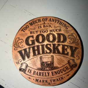 Round wood coaster laser-engraved with a vintage Mark Twain good whiskey design