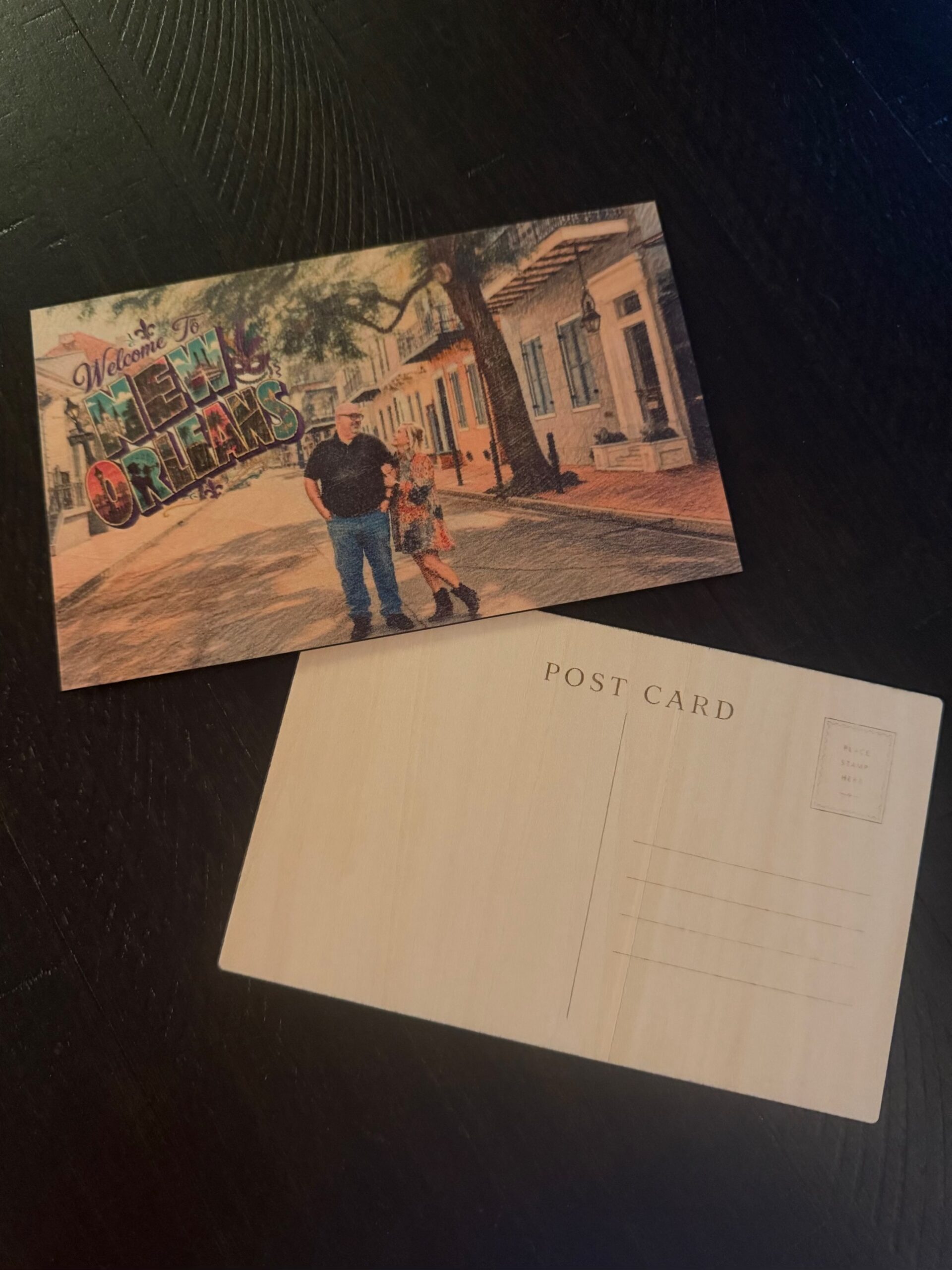 Personalized wooden postcard printed in full color with a couple's vacation photo and a Welcome to New Orleans greeting, shown with the engraved postcard back